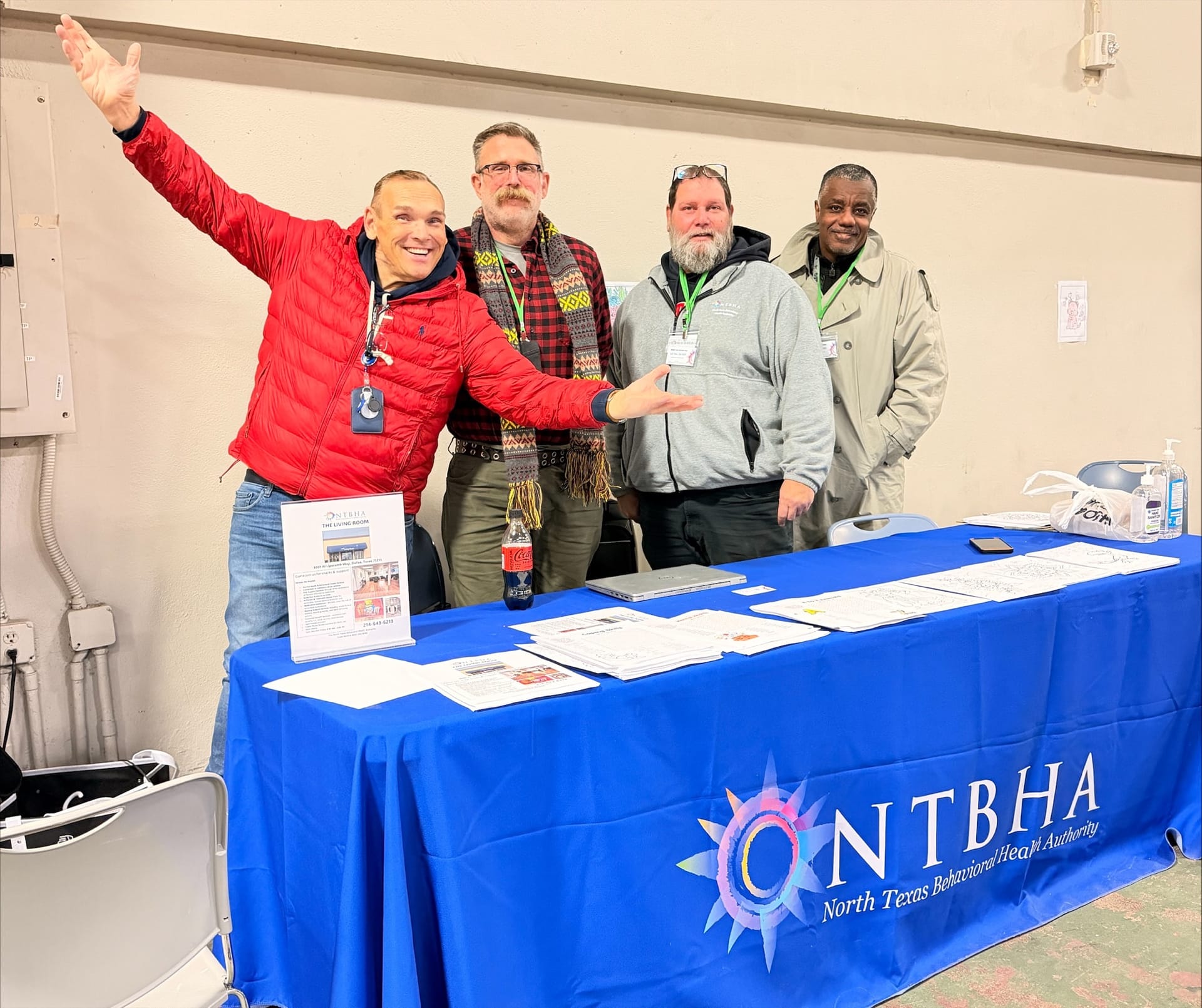 Group of four smiling men at a NTBHA resource table