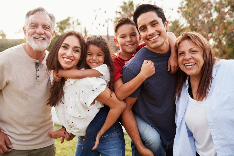 Multigenerational family smiling together outdoors