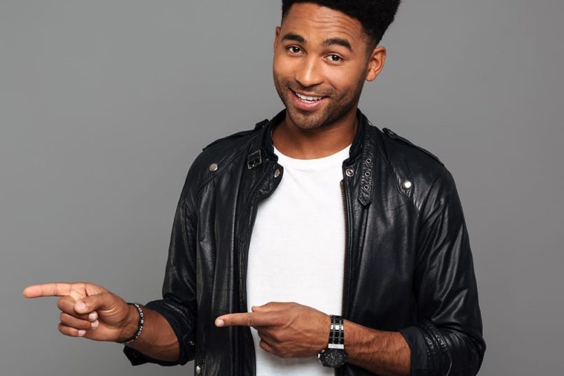 A man pointing two fingers in the same direction